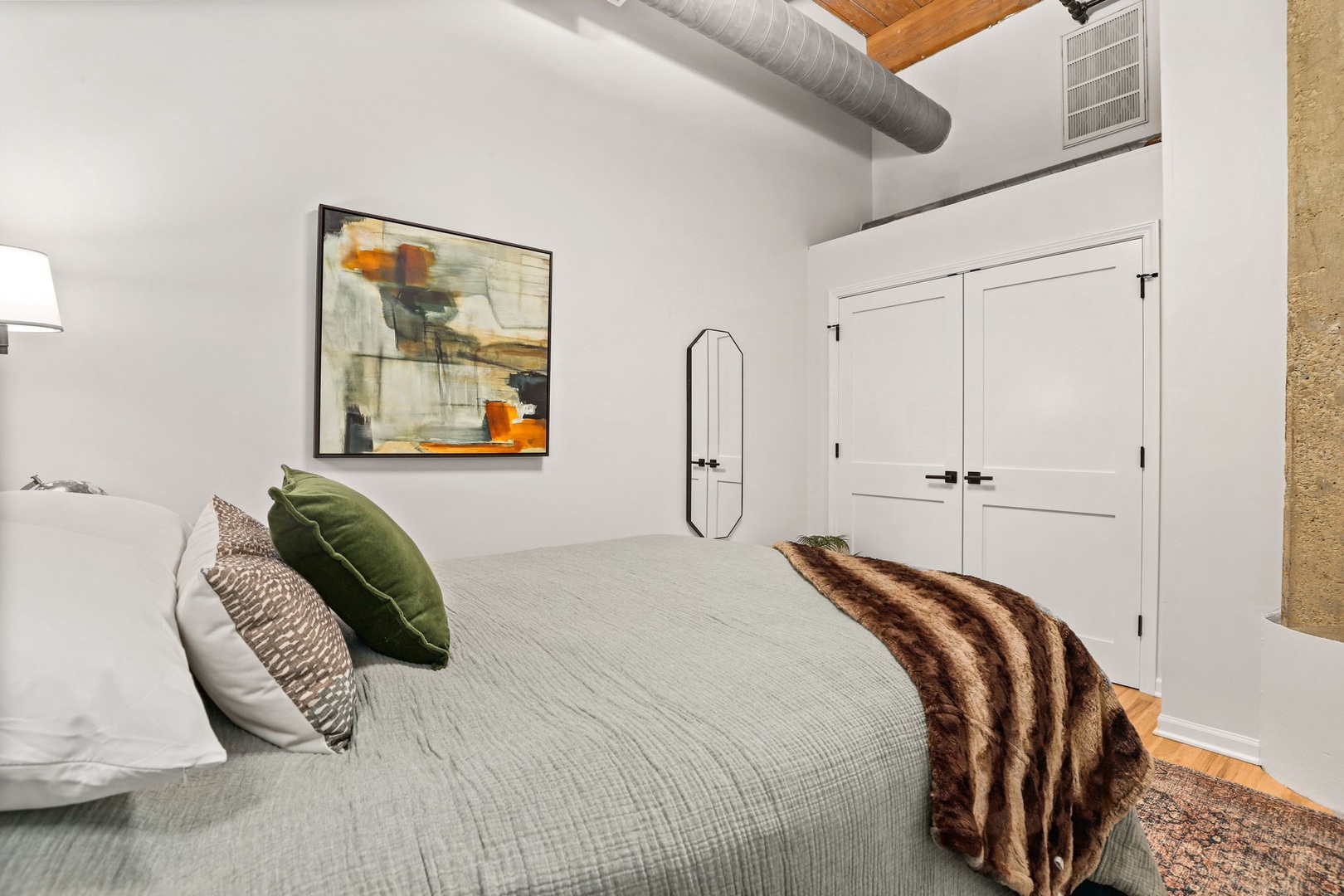 215 North Aberdeen Street, Unit 202B Chicago, IL 60607 - Photo 15 of 19 a bedroom with a bed and a painting on the wall