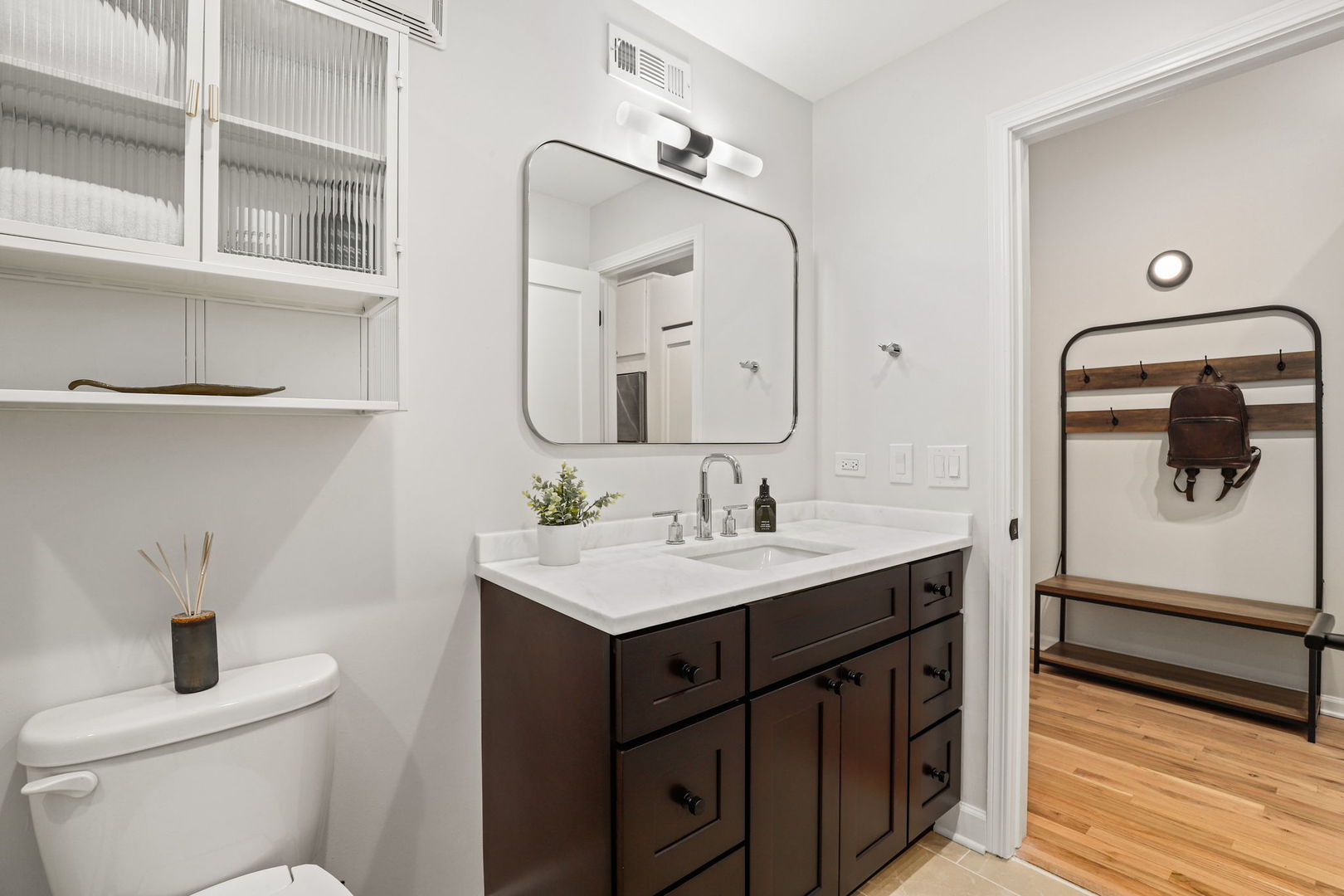 215 North Aberdeen Street, Unit 202B Chicago, IL 60607 - Photo 18 of 19 a bathroom with a toilet a sink and mirror