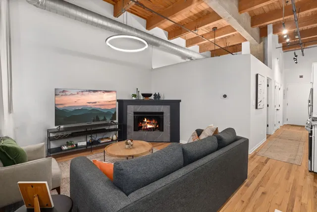 a living room with furniture a rug and a fireplace
