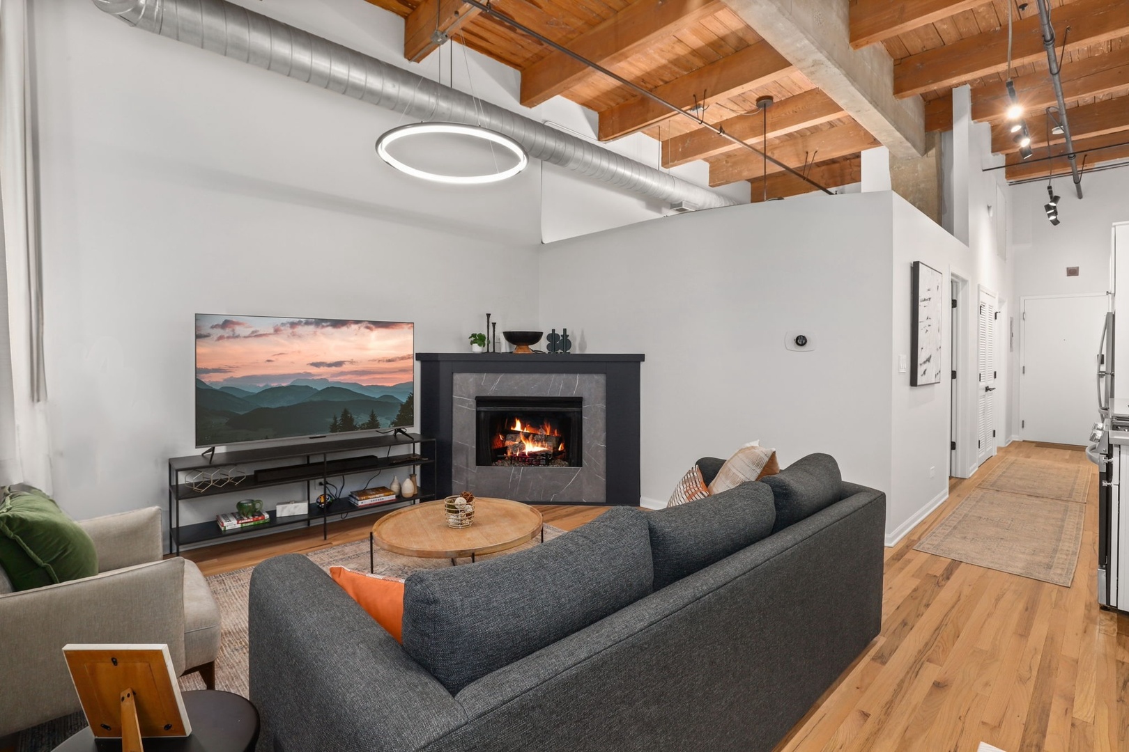 215 North Aberdeen Street, Unit 202B Chicago, IL 60607 - Photo 4 of 19 a living room with furniture and a flat screen tv