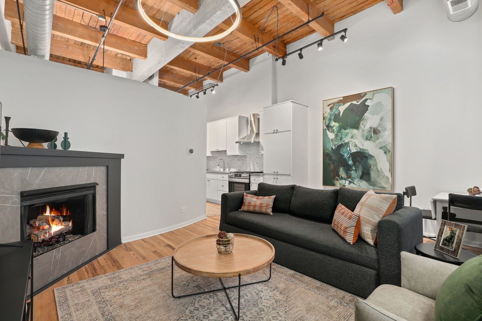 215 North Aberdeen Street, Unit 202B Chicago, IL 60607 - Photo 5 of 19 a living room with furniture a rug and a fireplace