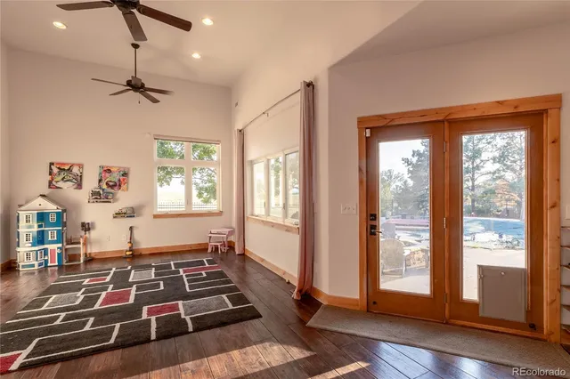 a room with lots of wooden floor and windows