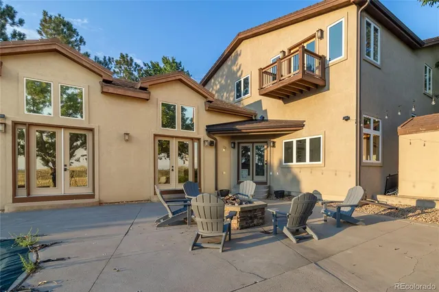 a view of a patio with table and chairs and potted plants