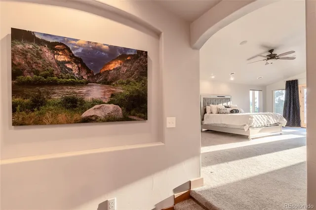 a view of a living room and with a ceiling fan