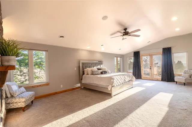 a spacious bedroom with a bed and a couch