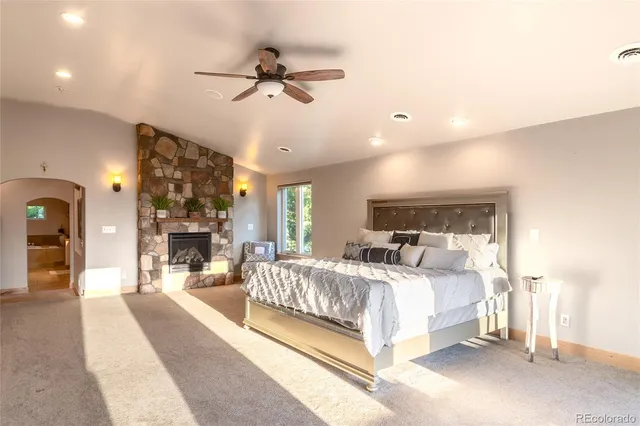 a bedroom with a large bed and a chandelier