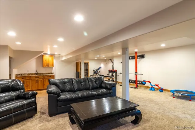 a living room with furniture and kitchen view
