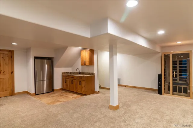 a large room with a large window and stainless steel appliances