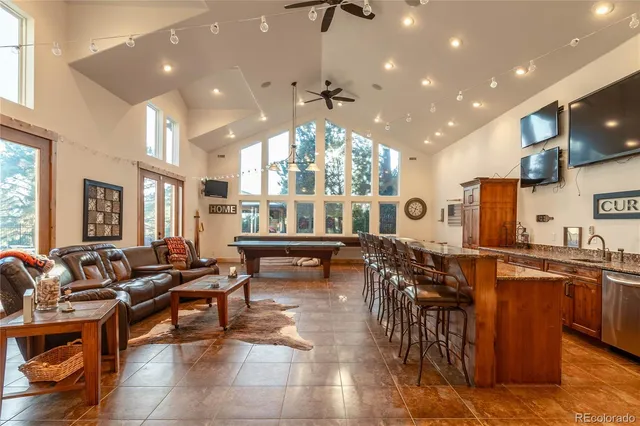 a very nice looking living room with a large dining table and a large window