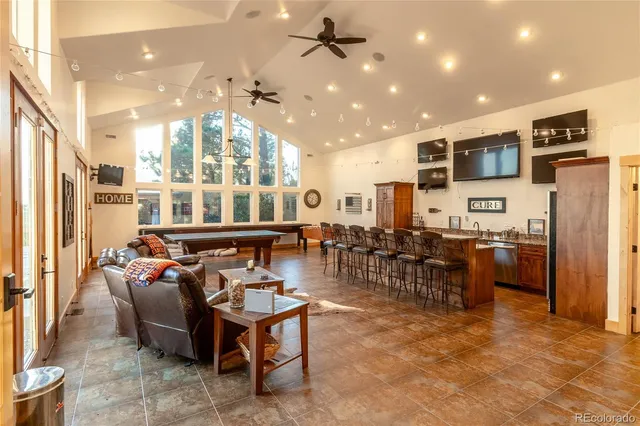 a living room with lots of furniture and kitchen view