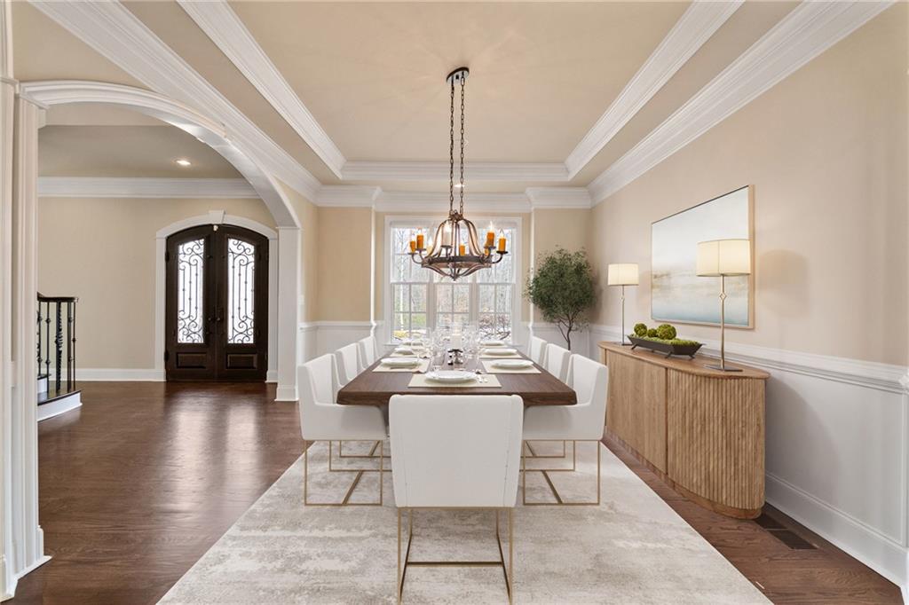 14560 Wood Road Milton, GA 30004 - Photo 14 of 74 a dining room with furniture a chandelier and wooden floor