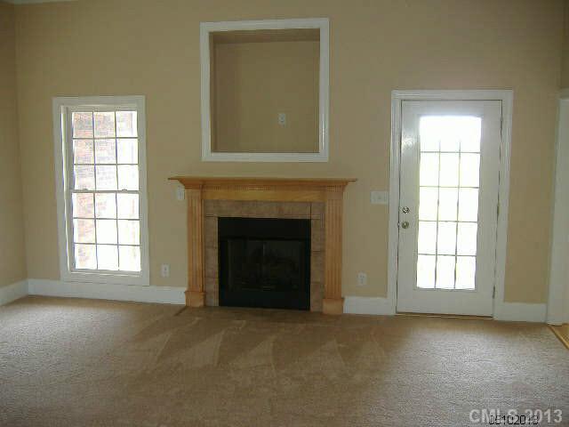 3827 Watson Church Road Monroe, NC 28110 - Photo 2 of 16 an empty room with windows and fireplace