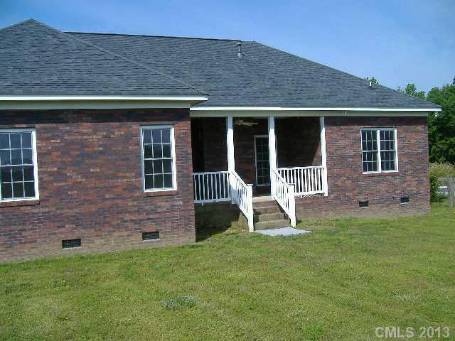 3827 Watson Church Road Monroe, NC 28110 - Photo 15 of 16 a front view of a house with garden and chairs