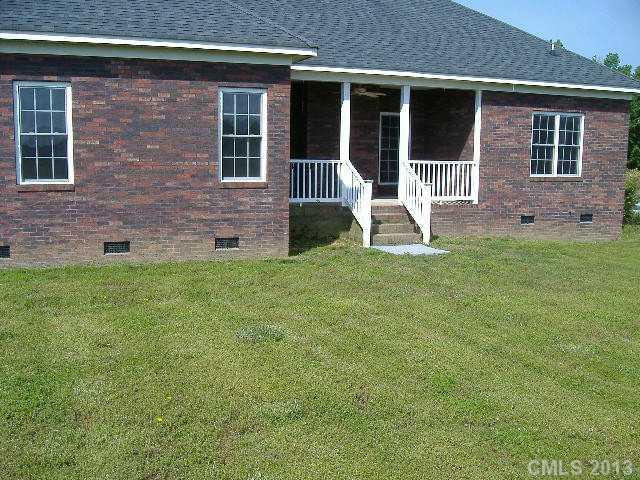 3827 Watson Church Road Monroe, NC 28110 - Photo 16 of 16 a view of house with backyard and front door