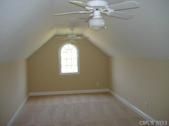 3827 Watson Church Road Monroe, NC 28110 - Photo 9 of 16 an empty room with a chandelier fan and windows