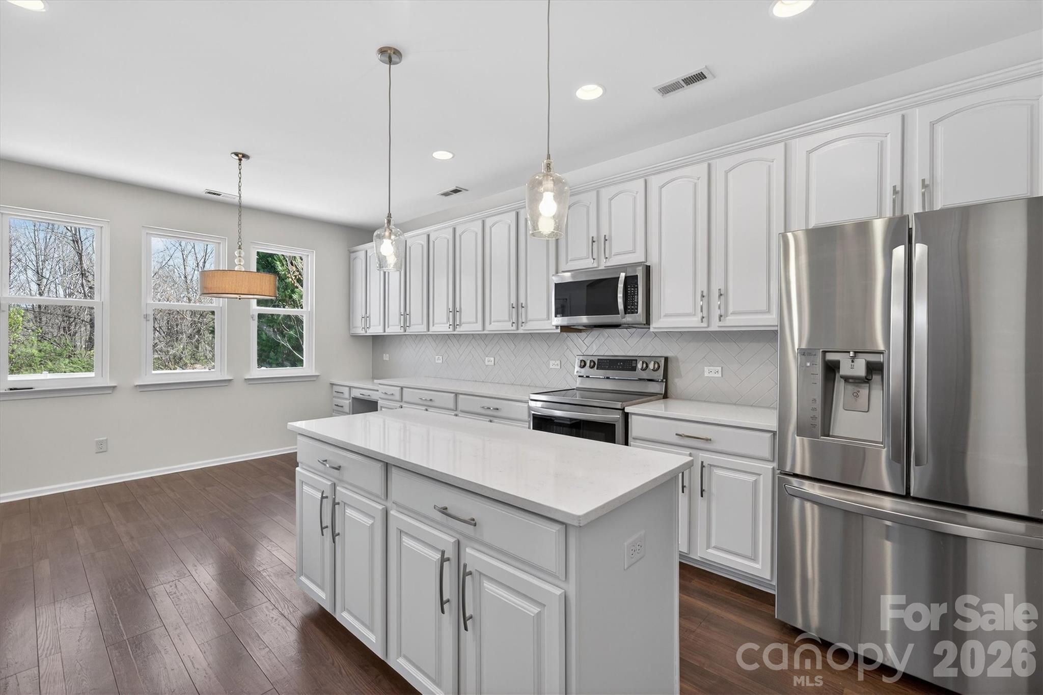 5527 Cactus Valley Road, Unit 183 Charlotte, NC 28277 - Photo 11 of 47 a kitchen with white cabinets and stainless steel appliances