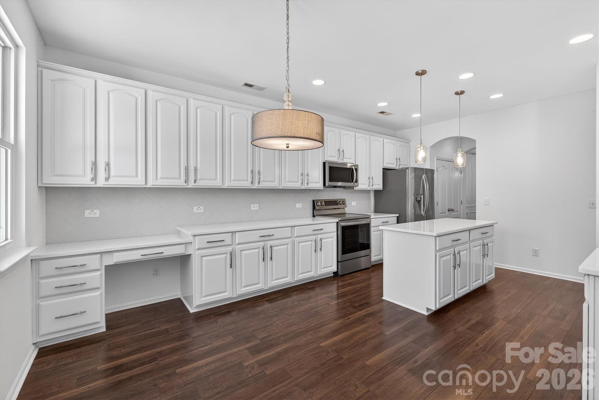 5527 Cactus Valley Road, Unit 183 Charlotte, NC 28277 - Photo 14 of 47 a kitchen with white cabinets stainless steel appliances and kitchen island
