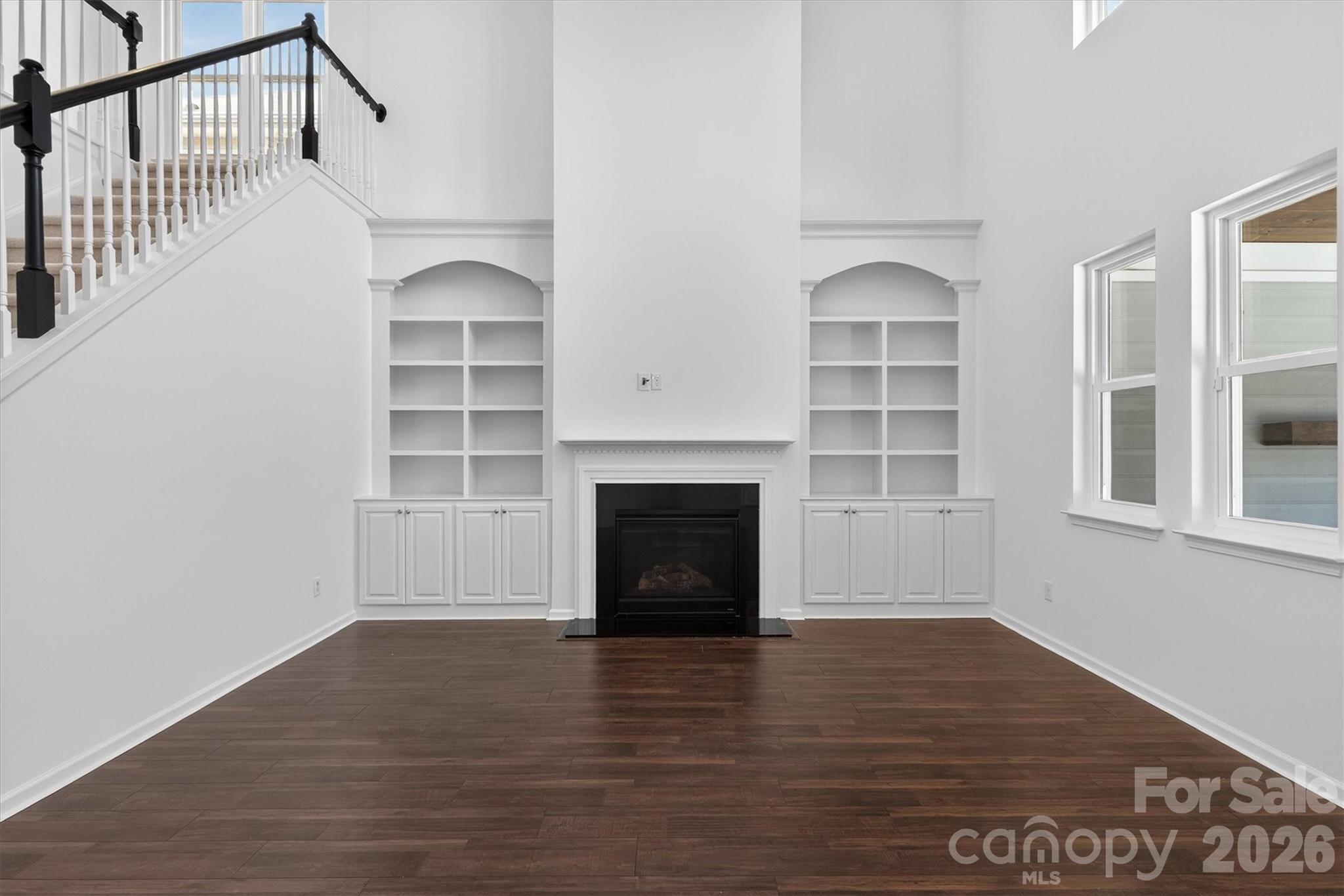 5527 Cactus Valley Road, Unit 183 Charlotte, NC 28277 - Photo 18 of 47 a view of an empty room with wooden floor fireplace and a window