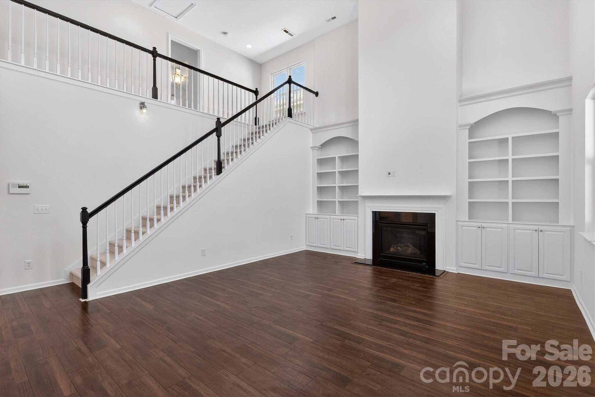 5527 Cactus Valley Road, Unit 183 Charlotte, NC 28277 - Photo 19 of 47 a view of an empty room with wooden floor fireplace and a window