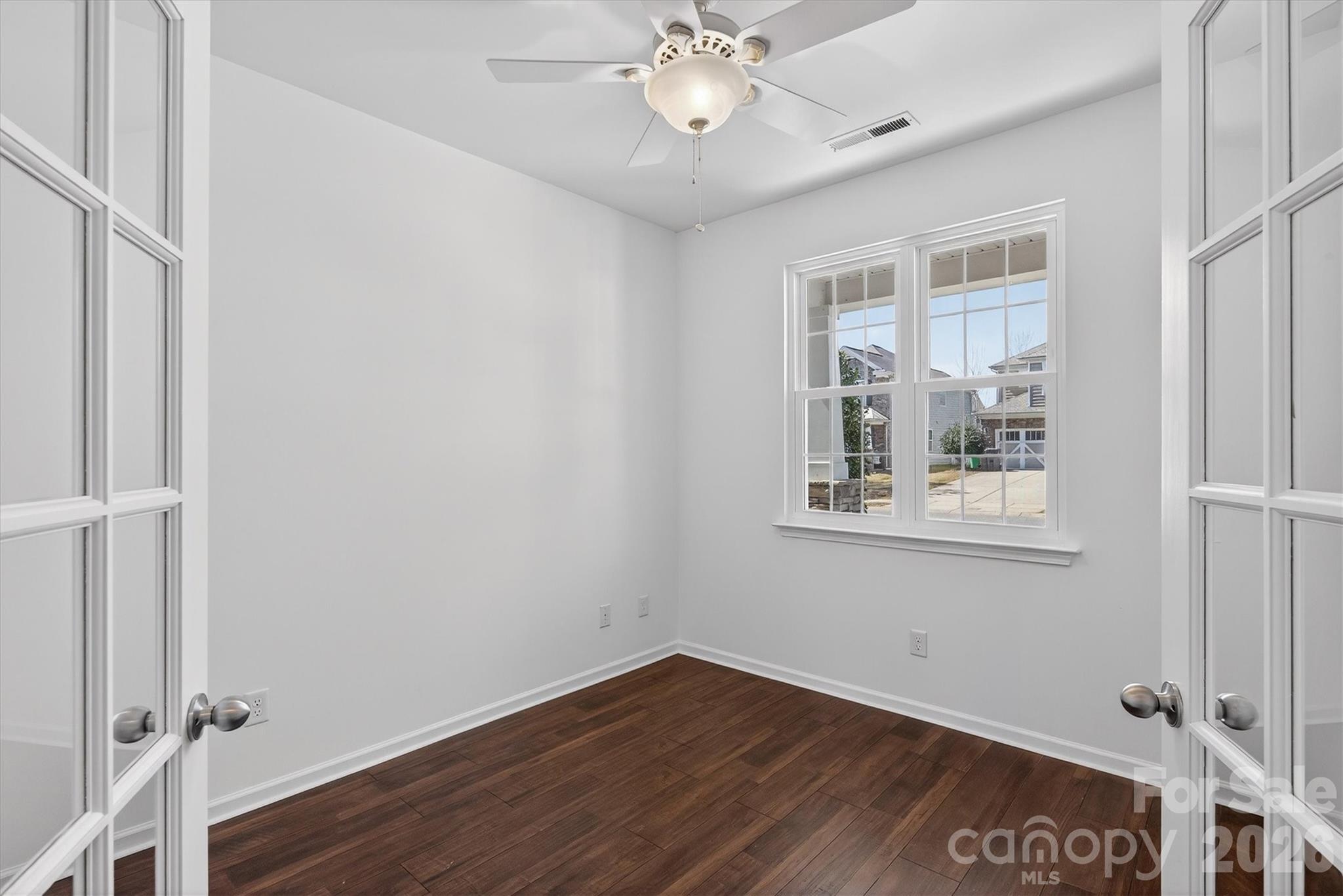5527 Cactus Valley Road, Unit 183 Charlotte, NC 28277 - Photo 7 of 47 a view of an empty room with wooden floor and a window