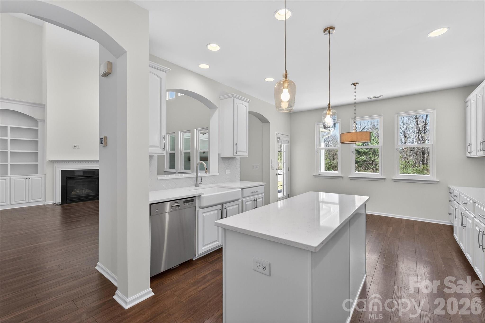 5527 Cactus Valley Road, Unit 183 Charlotte, NC 28277 - Photo 10 of 47 a large kitchen with kitchen island a stove a sink a center island and wooden floor
