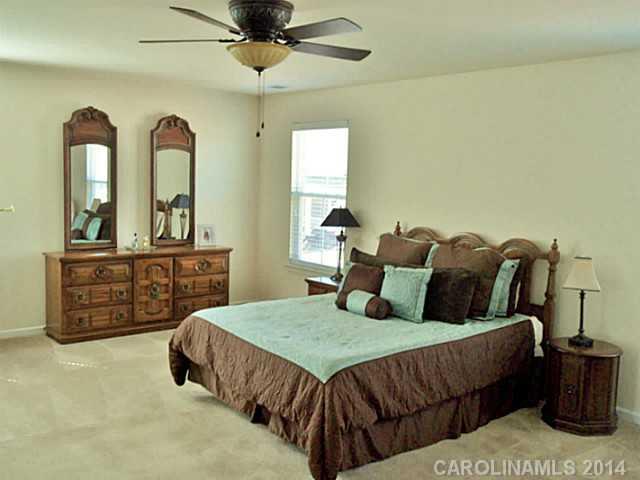 1018 Oakmere Road Waxhaw, NC 28173 - Photo 11 of 16 a bedroom with a bed and a dresser