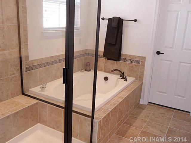 1018 Oakmere Road Waxhaw, NC 28173 - Photo 12 of 16 a bathroom with a tub and shower