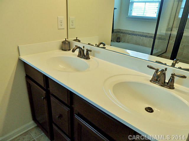 1018 Oakmere Road Waxhaw, NC 28173 - Photo 13 of 16 a bathroom with a double vanity sink and a mirror
