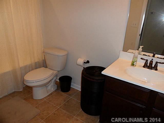 1018 Oakmere Road Waxhaw, NC 28173 - Photo 16 of 16 a bathroom with a sink toilet and mirror