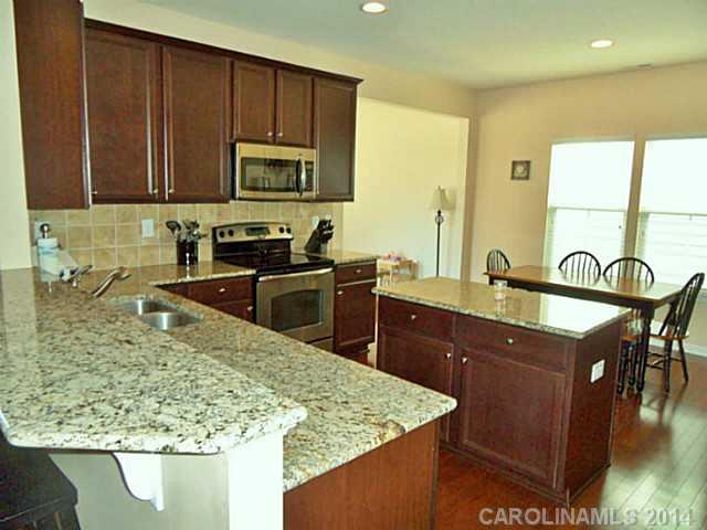 1018 Oakmere Road Waxhaw, NC 28173 - Photo 3 of 16 a kitchen with stainless steel appliances granite countertop a sink stove and microwave