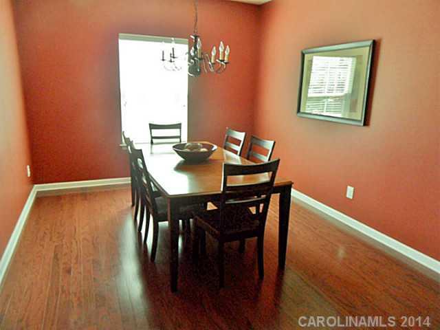 1018 Oakmere Road Waxhaw, NC 28173 - Photo 7 of 16 a view of a dining room with furniture and wooden floor