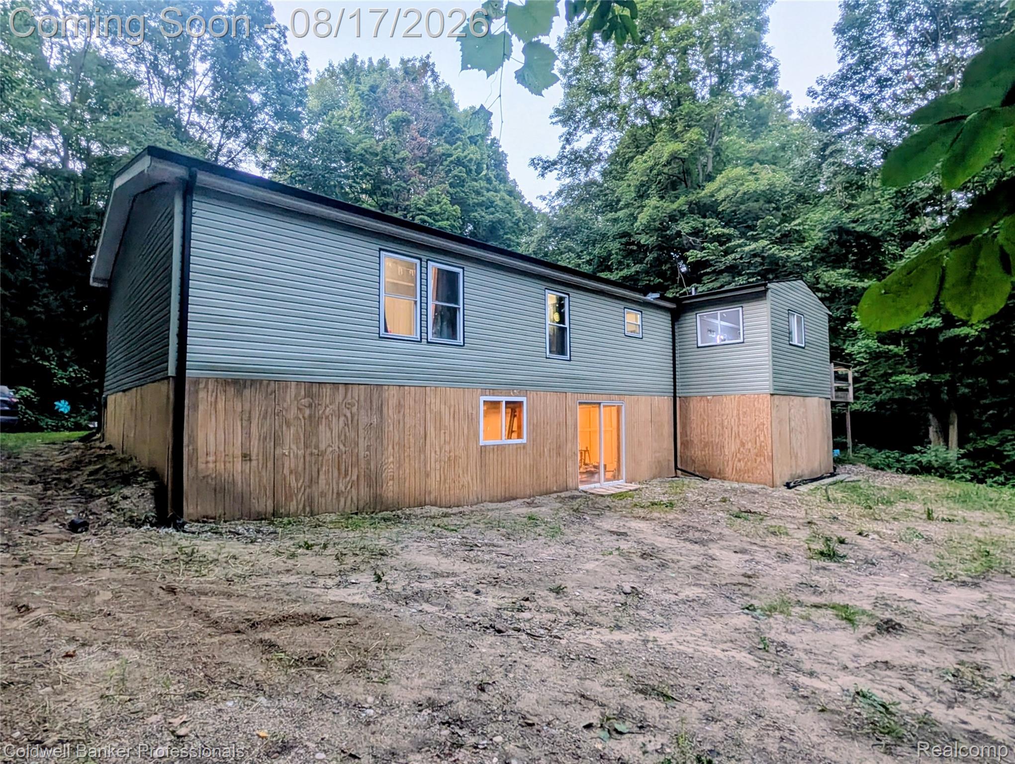 5323 English Road Clifford, MI 48727 - Photo 3 of 46 Two-story exterior with light green siding and wood-finish lower level