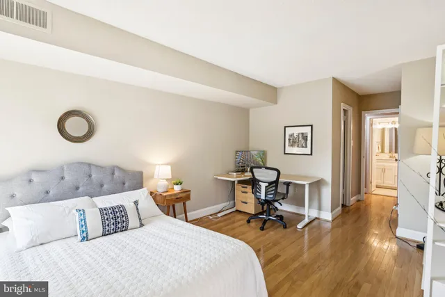 a bedroom with a bed and a table in it