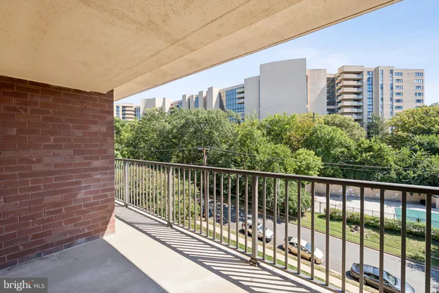 a balcony with trees in front of it
