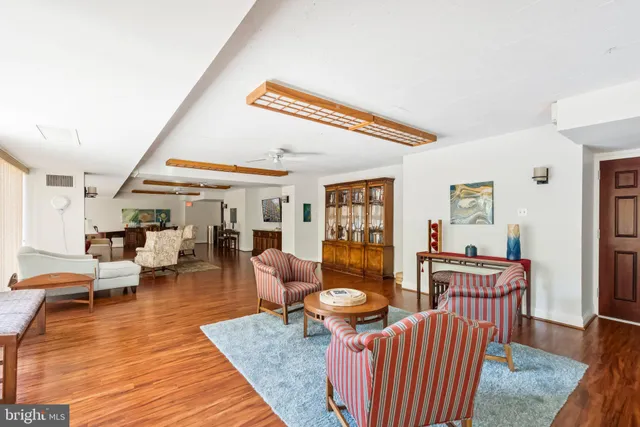 a living room with furniture a rug and a large window