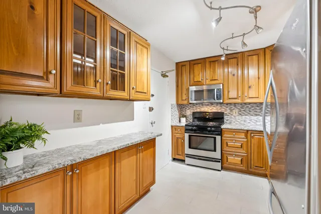 a kitchen with stainless steel appliances granite countertop a stove and a sink