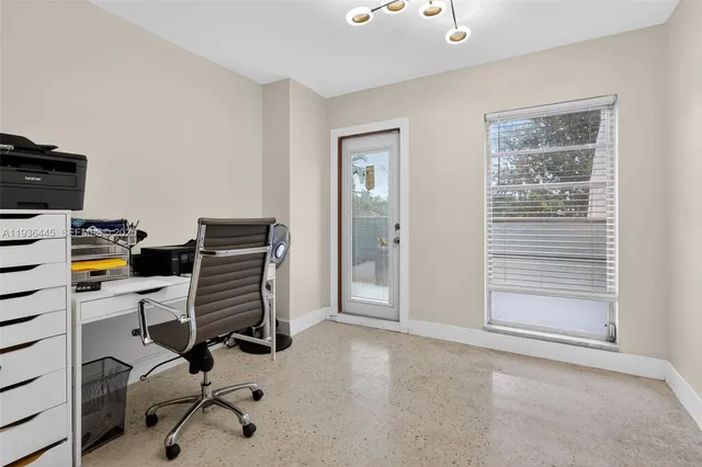 a living room with furniture and a dresser