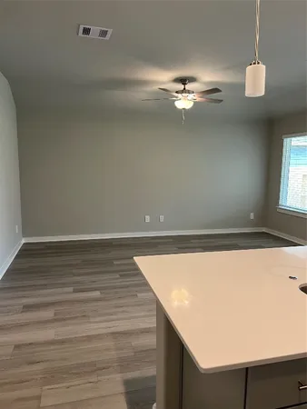 a view of a kitchen with a sink and a refrigerator