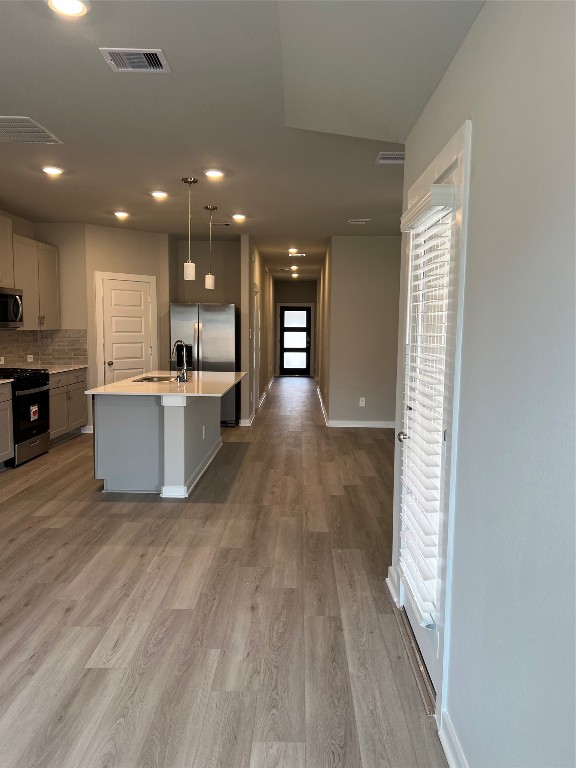 14330 Azalea Tree Drive Magnolia, TX 77354 - Photo 15 of 35 a view of a kitchen with kitchen island wooden floors wooden cabinets and stainless steel appliances