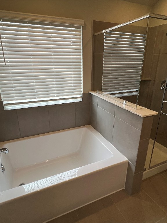 14330 Azalea Tree Drive Magnolia, TX 77354 - Photo 25 of 35 a bathroom with a bathtub and a window