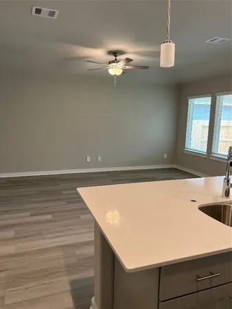 a view of a room with wooden floor and chandelier