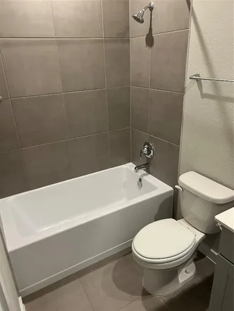a bathroom with a toilet and bathtub