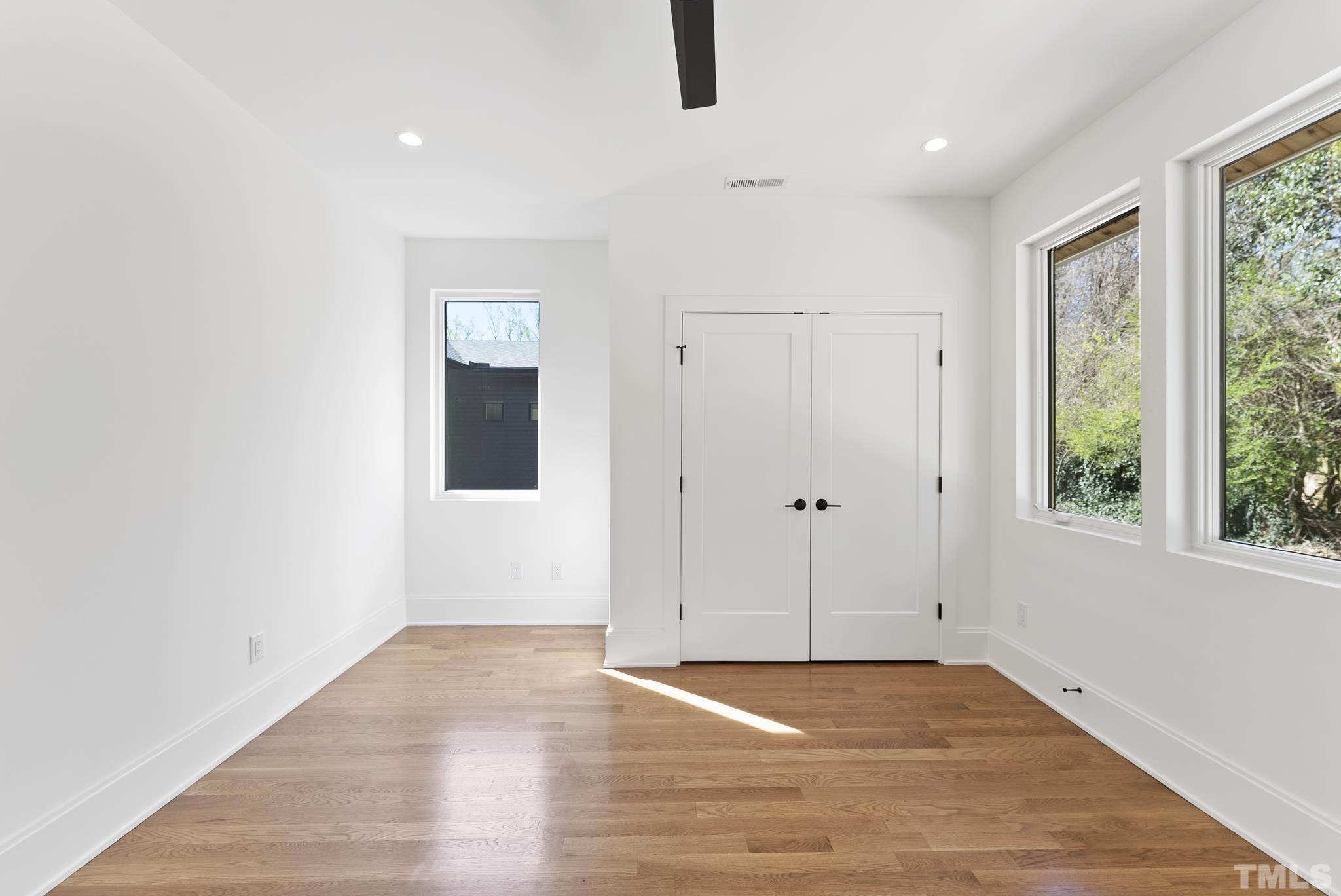 1621 Nottingham Road Raleigh, NC 27607 - Photo 29 of 49 an empty room with wooden floor and windows