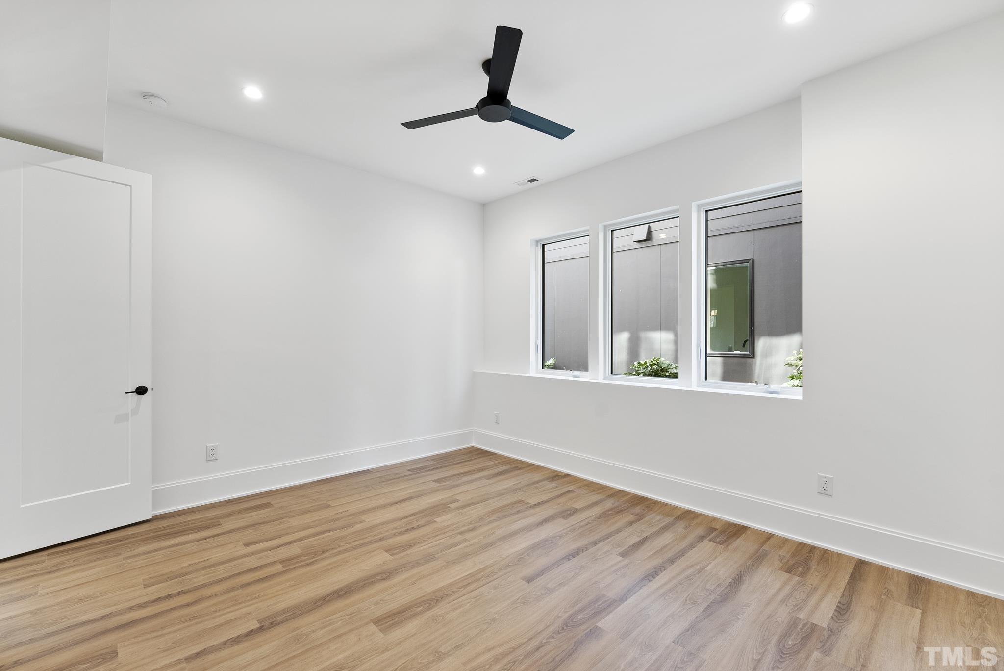 1621 Nottingham Road Raleigh, NC 27607 - Photo 36 of 49 a view of an empty room with wooden floor and a window