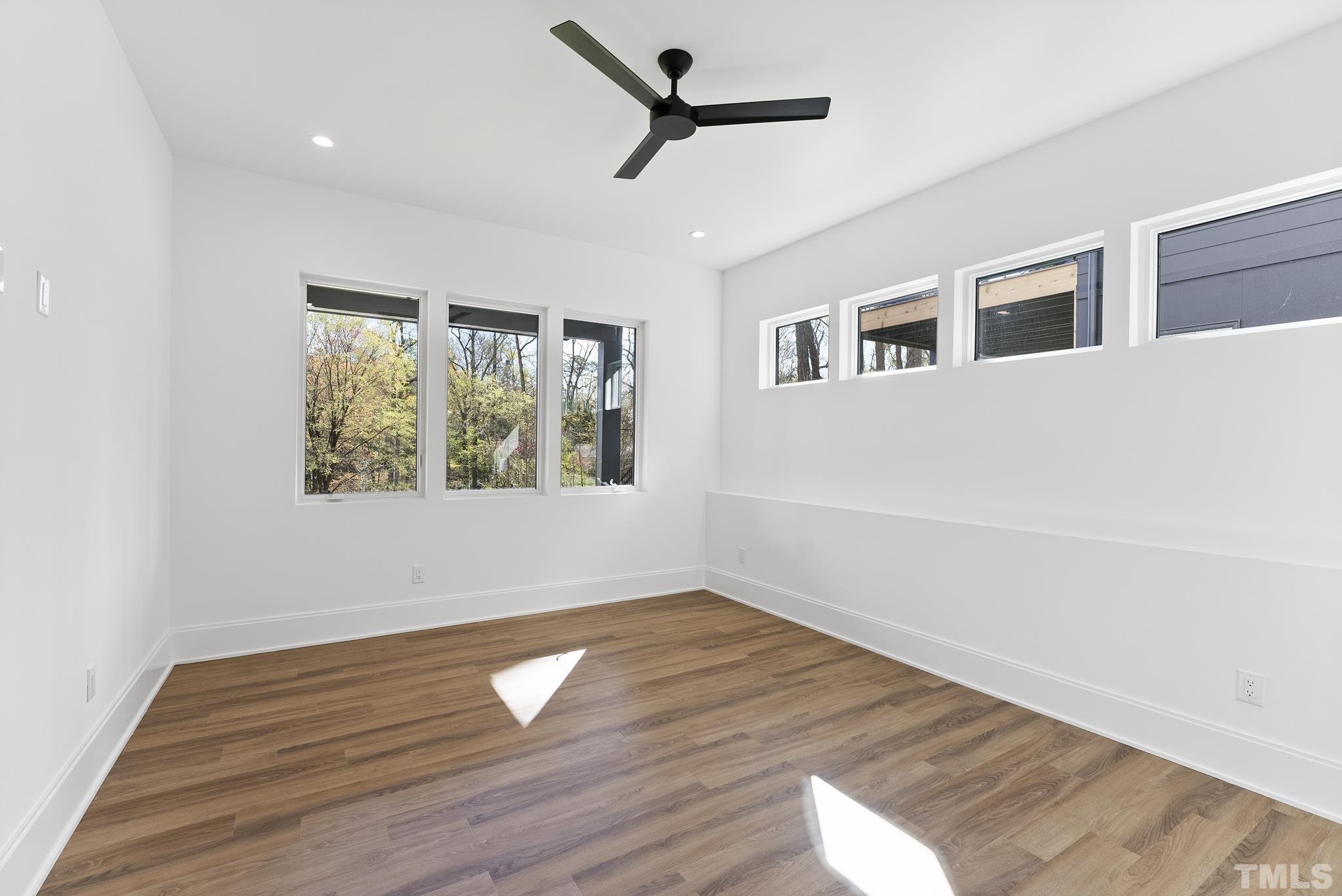 1621 Nottingham Road Raleigh, NC 27607 - Photo 38 of 49 a view of empty room with wooden floor and fan