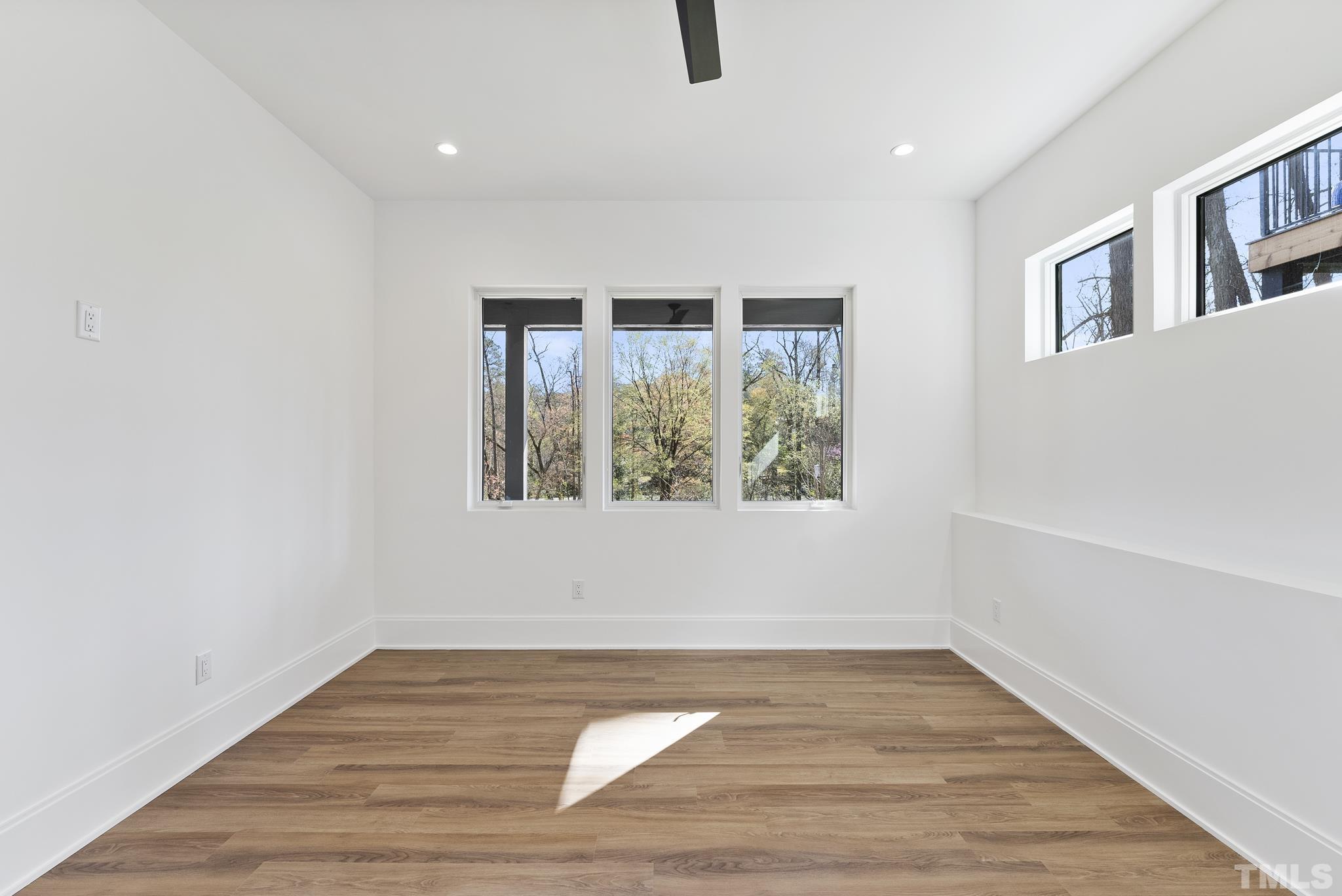 1621 Nottingham Road Raleigh, NC 27607 - Photo 39 of 49 a view of an empty room with wooden floor and a window