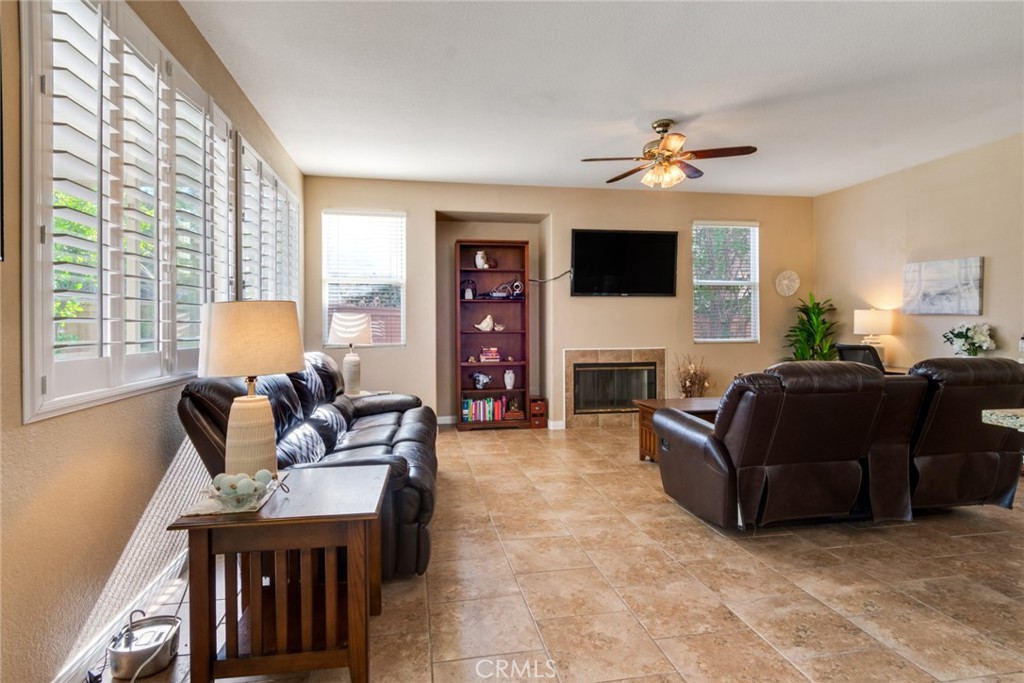 20885 Bakal Drive Riverside, CA 92508 - Photo 10 of 47 a living room with furniture a fireplace and a flat screen tv