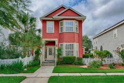 a front view of a house with a yard and green space