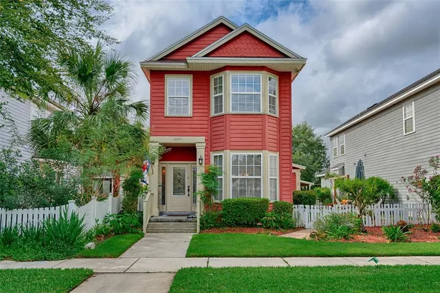 a front view of a house with a yard and green space