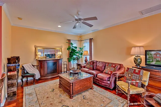 a living room with furniture a rug and a large window